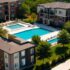 Aerial view of an apartment complex with multiple buildings and parking lots